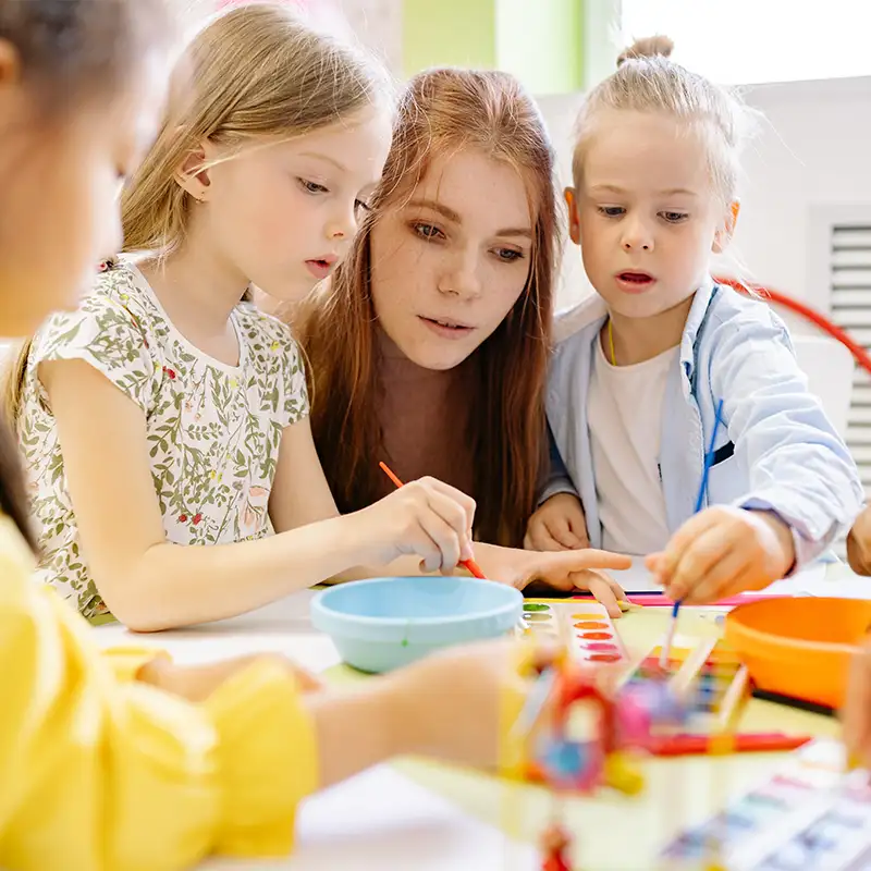 Nursery teacher with toddlers